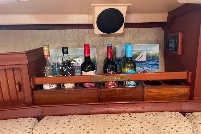 Slide: The Image of 1994 Island Packet 44 cutter interior with spirit locker and assorted bottles. - 66