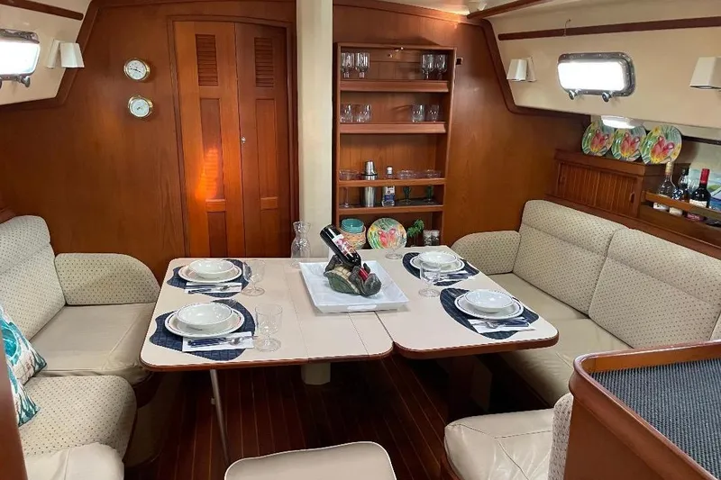 Slide: The Image of Luxurious 1994 Island Packet 44 cutter yacht interior with elegant dining setup. - 67
