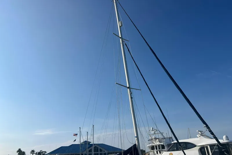 Slide: The Image of Tall mast of a 1994 Island Packet 44 cutter sailboat against a clear blue sky. - 7