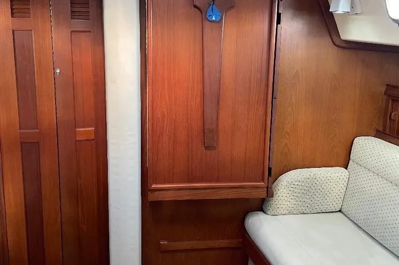 Slide: The Image of Interior of 1994 Island Packet 44 cutter with wooden cabinetry and cushioned seating. - 70