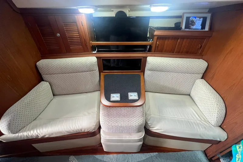 Slide: The Image of Interior of 1994 Island Packet 44 cutter with cozy seating and wooden cabinetry. - 73