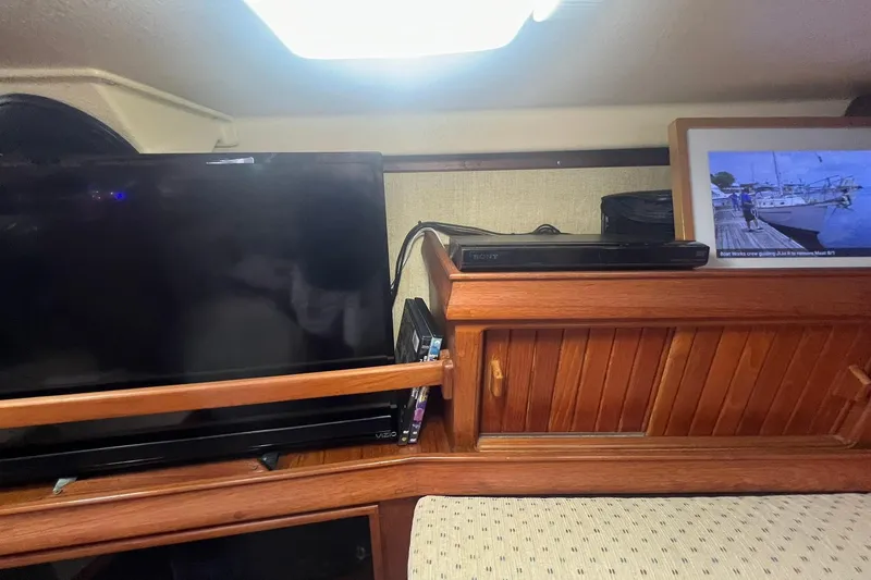 Slide: The Image of Interior of 1994 Island Packet 44 cutter with TV and wooden cabinetry. - 74