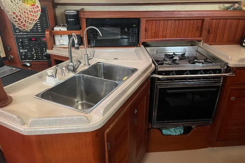 Slide: The Image of Galley kitchen in 1994 Island Packet 44 cutter sailboat with stove and sink. - 79
