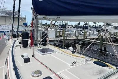 Slide: The Image of 1994 Island Packet 44 cutter sailboat docked at marina, showcasing deck and rigging. - 8