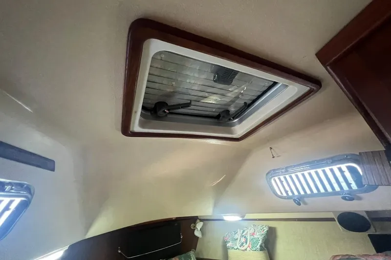 Slide: The Image of Interior cabin view of a 1994 Island Packet 44 cutter sailboat, featuring a ceiling hatch. - 90