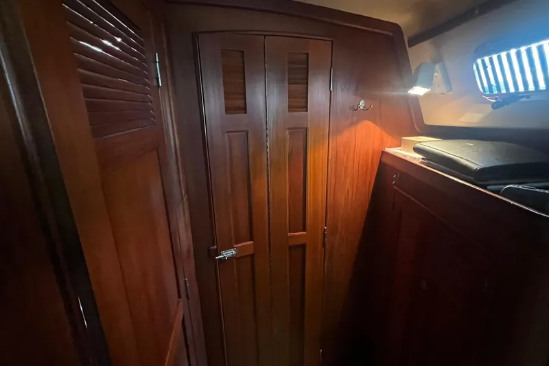 Slide: The Image of Interior of 1994 Island Packet 44 cutter, featuring wooden cabinetry and ambient lighting. - 93