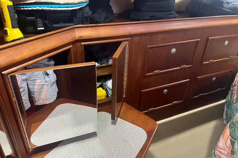Slide: The Image of Interior of 1994 Island Packet 44 cutter with wooden cabinets and mirror. - 96