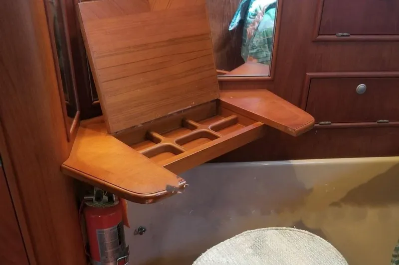 Slide: The Image of Interior of 1994 Island Packet 44 cutter with wooden fold-out desk and fire extinguisher. - 97