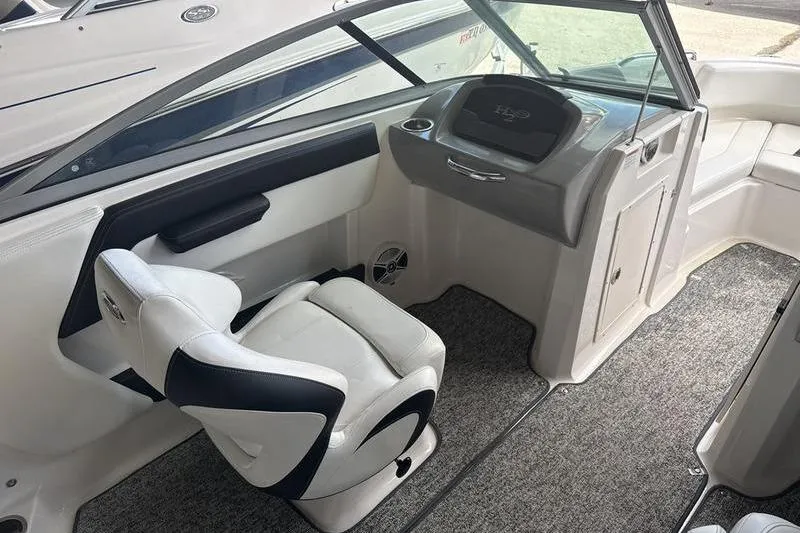 Slide: The Image of 2018 Chaparral 21 H2O Sport boat interior with white seating and carpeted floor. - 9