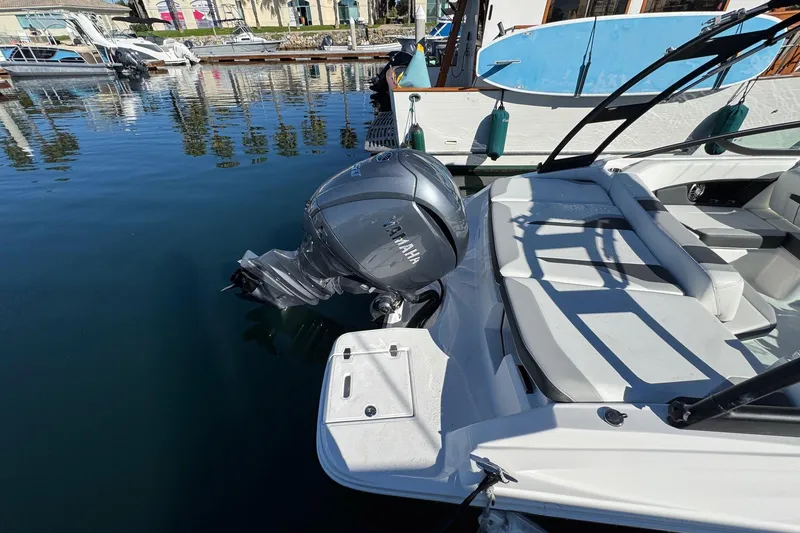 Slide: The Image of 2026 Regal 21 OBX boat with Yamaha outboard motor docked in marina. - 10