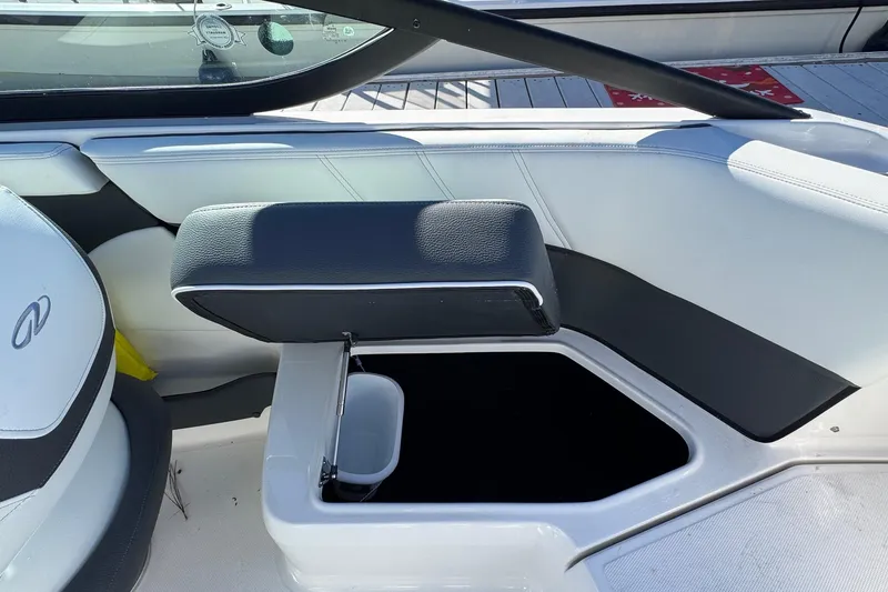 Slide: The Image of 2026 Regal 21 OBX boat interior with open storage compartment and cushioned seating. - 19