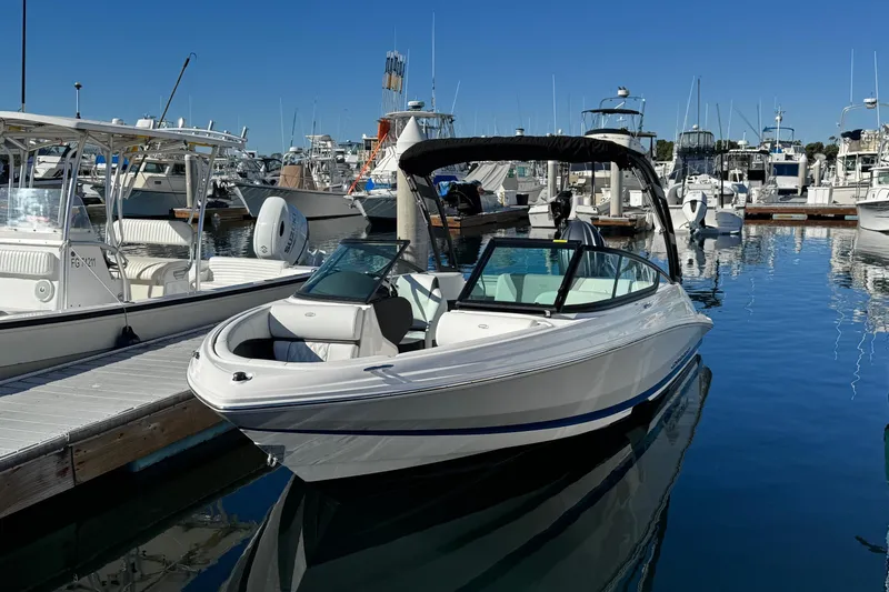 Slide: The Image of 2026 Regal 21 OBX boat docked in a marina under clear blue skies. - 3