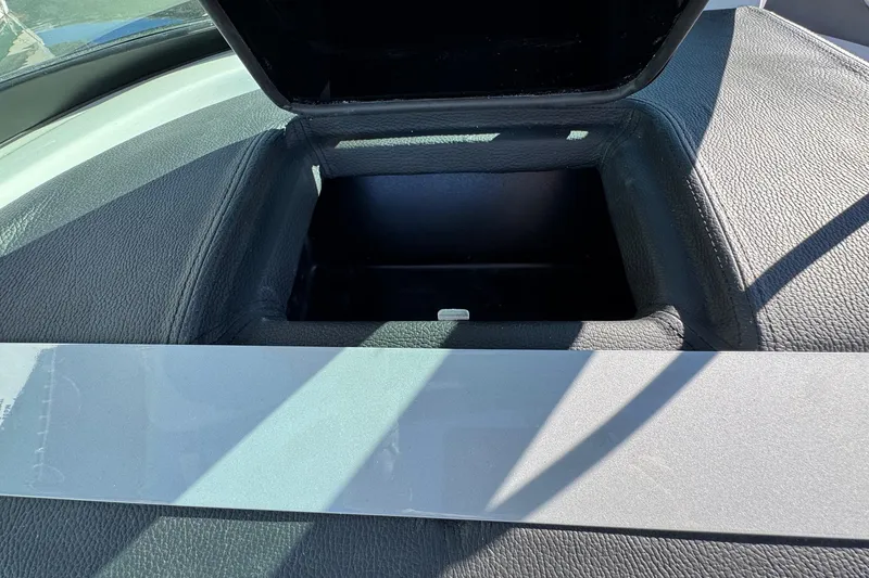 Slide: The Image of Open storage compartment in 2026 Regal 21 OBX boat dashboard. - 31