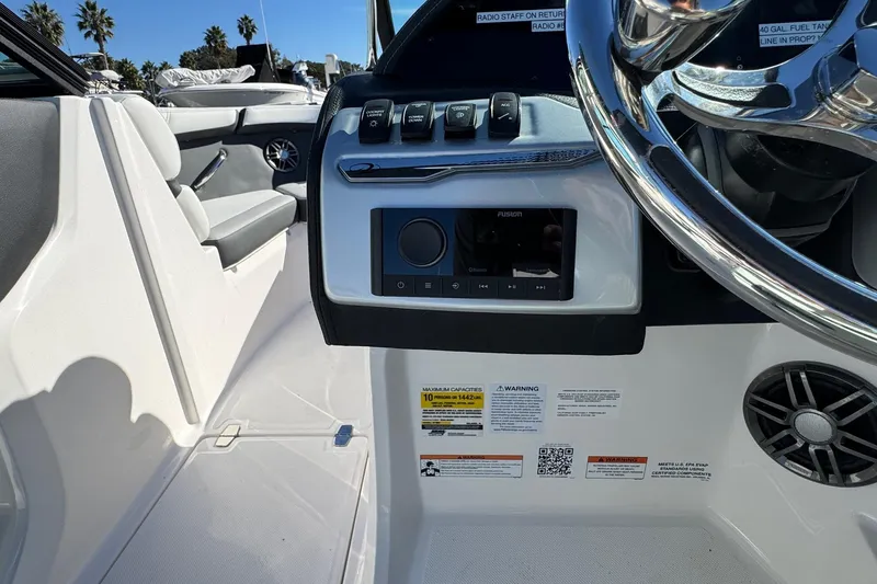 Slide: The Image of 2026 Regal 21 OBX boat dashboard with controls and steering wheel. - 36