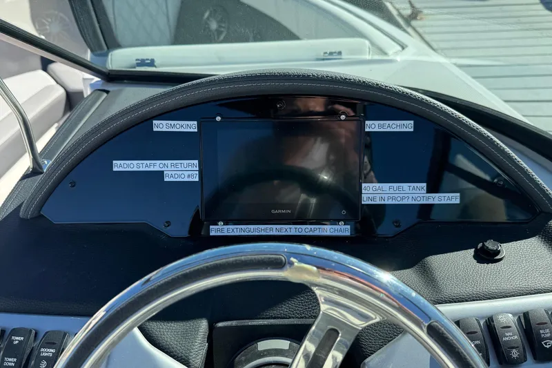 Slide: The Image of 2026 Regal 21 OBX dashboard with safety labels and Garmin display. - 39