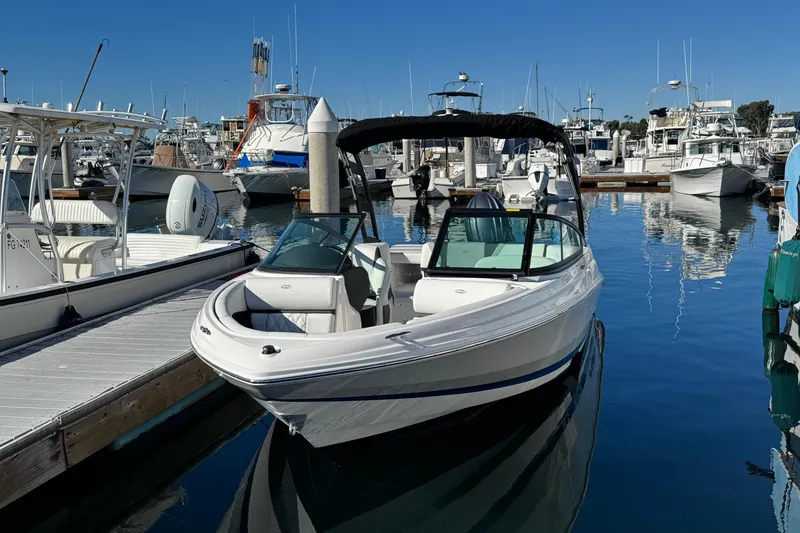 Slide: The Image of 2026 Regal 21 OBX boat docked in a marina, surrounded by other vessels. - 4