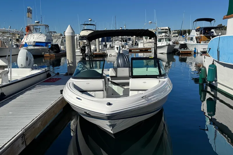 Slide: The Image of 2026 Regal 21 OBX boat docked at a marina, surrounded by other vessels. - 5