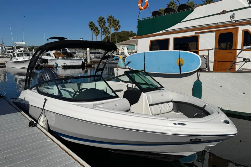 Slide: The Image of 2026 Regal 21 OBX boat docked at marina with clear blue sky. - 8