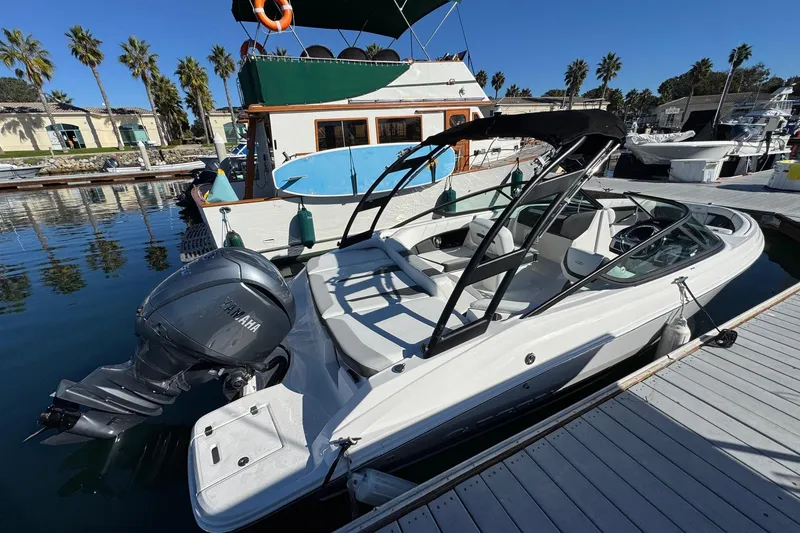 Slide: The Image of 2026 Regal 21 OBX boat docked at marina with Yamaha outboard motor. - 9