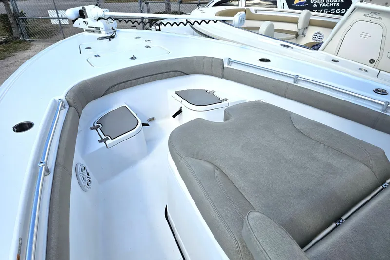 Slide: The Image of 2021 Sportsman Masters 267OE Bay Boat interior with cushioned seating and storage compartments. - 12