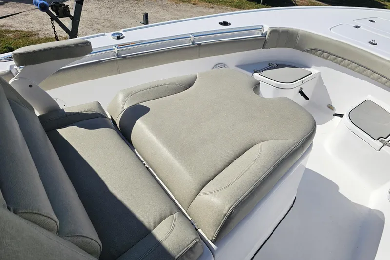 Slide: The Image of 2021 Sportsman Masters 267OE Bay Boat interior with cushioned seating and storage compartments. - 15