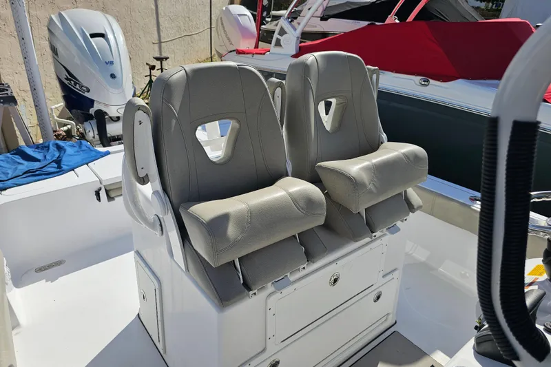 Slide: The Image of 2021 Sportsman Masters 267OE Bay Boat with dual gray captain's chairs. - 16