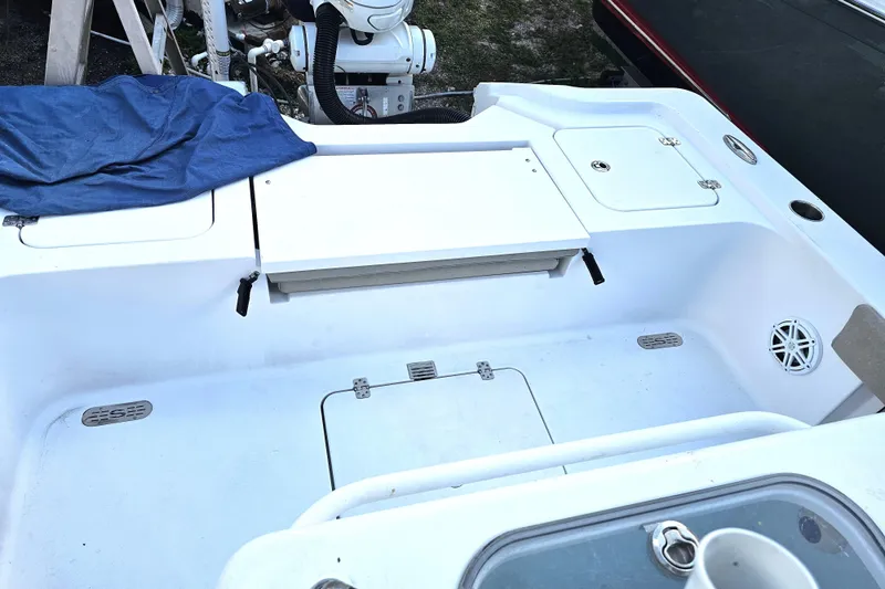 Slide: The Image of 2021 Sportsman Masters 267OE Bay Boat deck with storage compartments and seating area. - 22