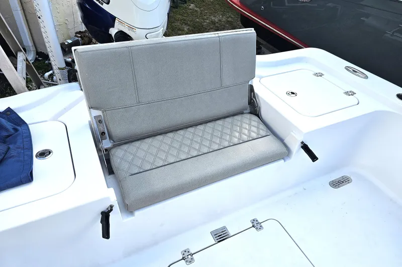 Slide: The Image of 2021 Sportsman Masters 267OE Bay Boat with gray cushioned seating and storage compartments. - 23