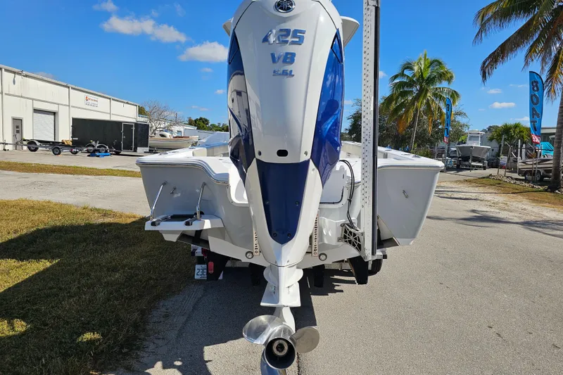 Slide: The Image of 2021 Sportsman Masters 267OE Bay Boat with powerful outboard motor, parked outdoors. - 3