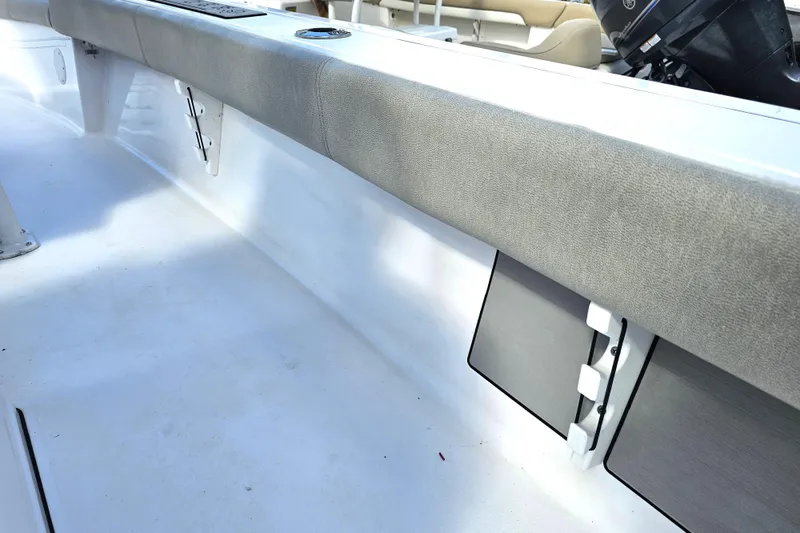 Slide: The Image of 2021 Sportsman Masters 267OE Bay Boat interior with cushioned seating and storage compartments. - 35