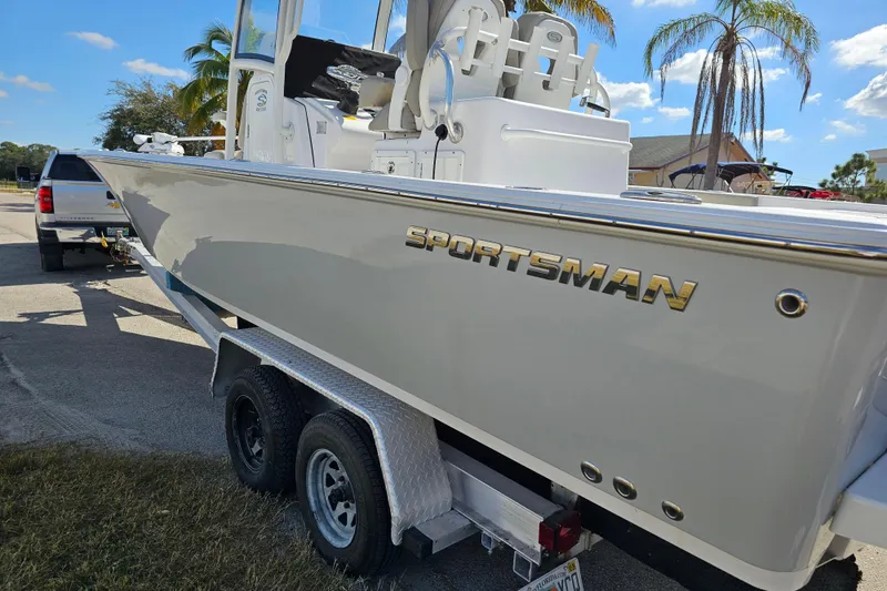 Slide: The Image of 2021 Sportsman Masters 267OE Bay Boat on trailer, parked outdoors under clear sky. - 4