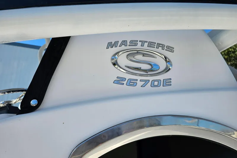 Slide: The Image of 2021 Sportsman Masters 267OE Bay Boat logo on white surface. - 7