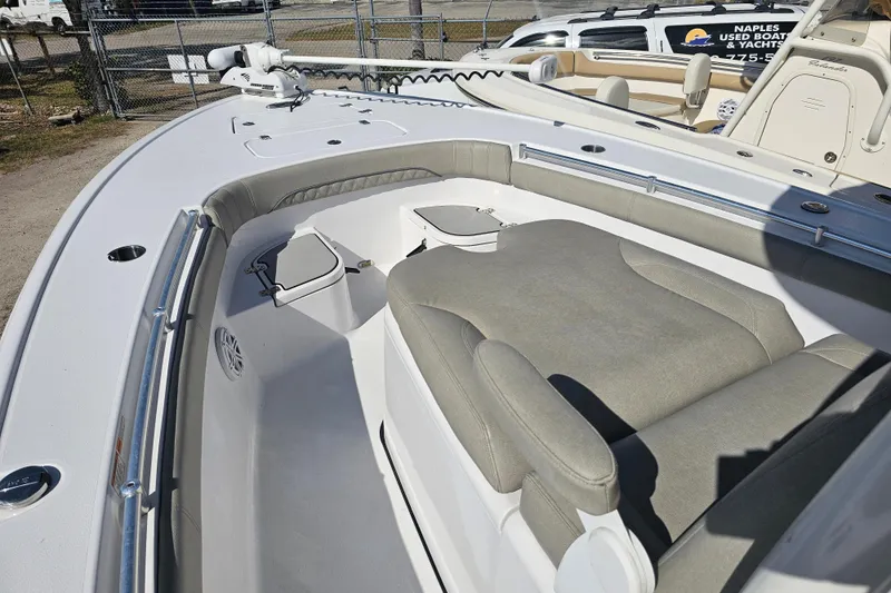 Slide: The Image of 2021 Sportsman Masters 267OE Bay Boat interior with cushioned seating and storage compartments. - 8