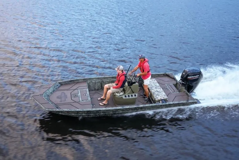 Slide: The Image of 2026 Tracker Grizzly 1860 Center Console boat cruising on a lake with two passengers. - 13