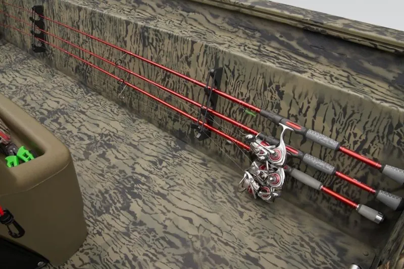 Slide: The Image of 2026 Tracker Grizzly 1860 Center Console with camo interior and fishing rod holders. - 14