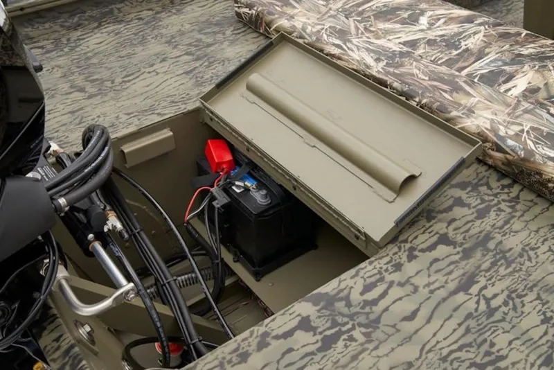 Slide: The Image of 2026 Tracker Grizzly 1860 Center Console boat battery compartment with camouflage design. - 7