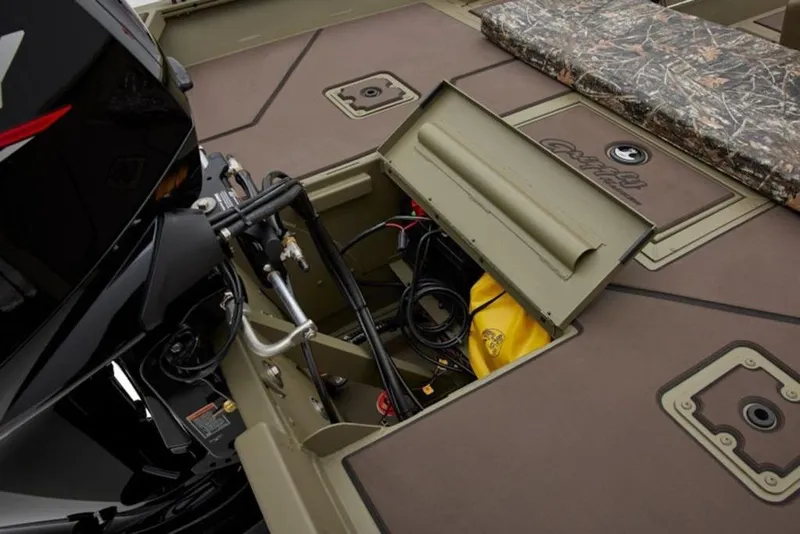 Slide: The Image of 2026 Tracker Grizzly 2072 Center Console boat with open storage compartment and engine details. - 6