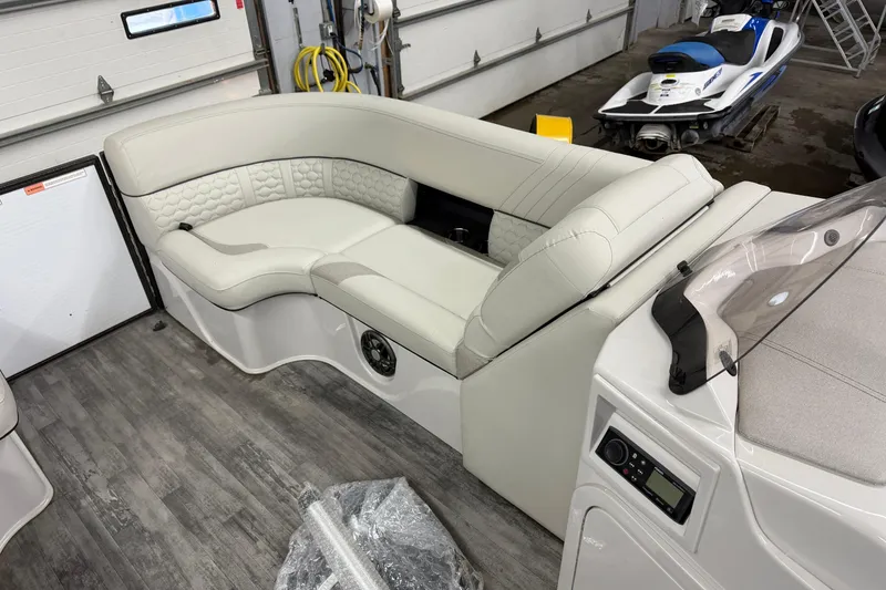 Slide: The Image of Luxurious seating in 2021 Crest Caribbean LX 230 SLC boat, featuring elegant white upholstery. - 11