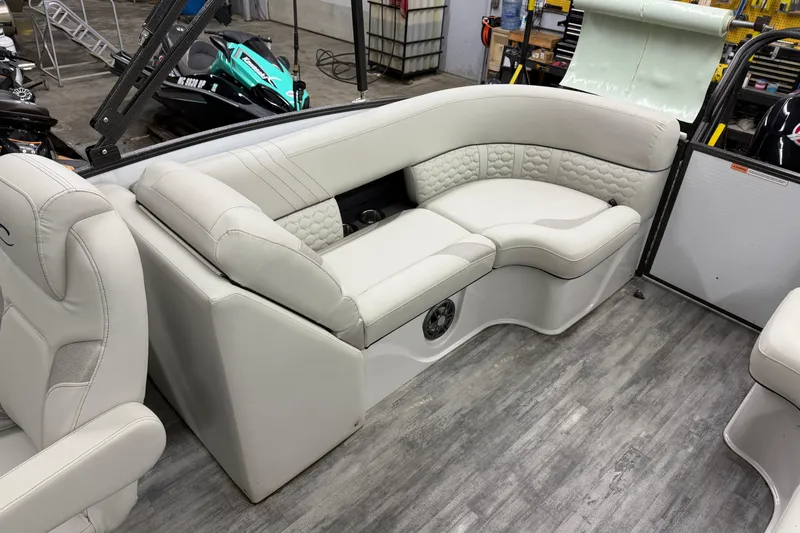 Slide: The Image of Luxurious seating in 2021 Crest Caribbean LX 230 SLC boat, featuring elegant white upholstery. - 15