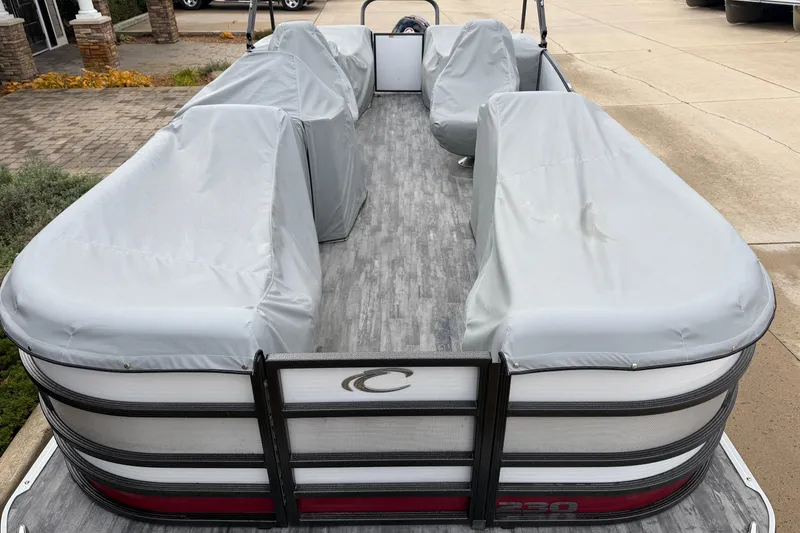 Slide: The Image of 2021 Crest Caribbean LX 230 SLC pontoon boat in a garage with canopy. - 2