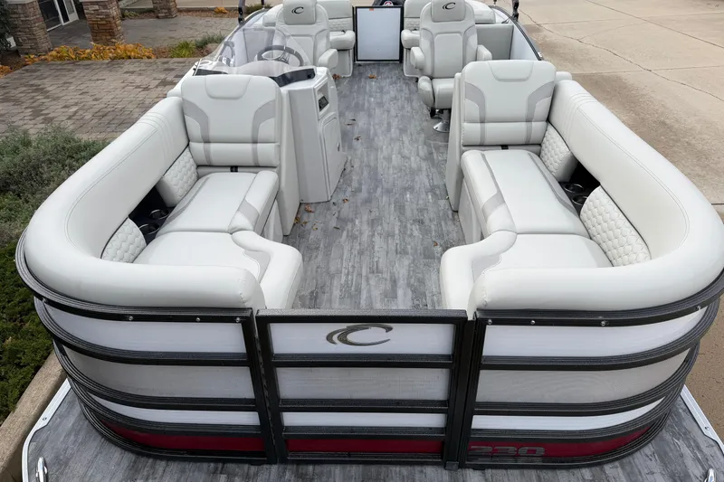 Slide: The Image of 2021 Crest Caribbean LX 230 SLC pontoon boat in a garage with black canopy. - 3