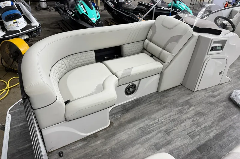 Slide: The Image of Luxurious seating in 2021 Crest Caribbean LX 230 SLC boat, featuring elegant white upholstery. - 6