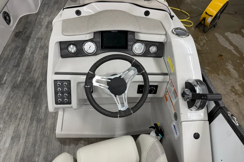 Slide: The Image of 2021 Crest Caribbean LX 230 SLC boat interior with luxurious seating and steering wheel. - 9