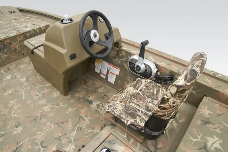 Slide: The Image of 2026 Tracker Grizzly 1754 SC boat interior with camo seat and steering console. - 12