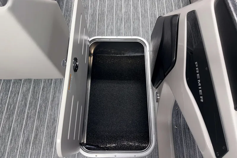 Slide: The Image of Open storage compartment on 2026 Premier 230 SunSation RF Tritoon boat, featuring sleek interior design. - 10