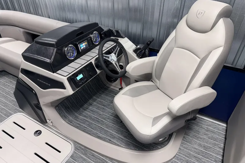 Slide: The Image of Luxurious interior of 2026 Premier 230 SunSation RF Tritoon with modern dashboard and captain's chair. - 5