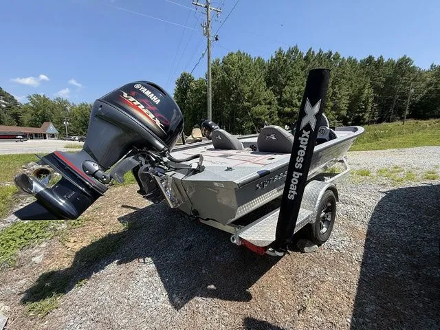 The Image of 2023 Xpress Boats H18 with Yamaha engine, parked outdoors on gravel. - 1