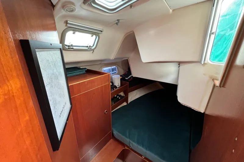 Slide: The Image of Cozy cabin interior of 1995 Beneteau Oceanis 351 sailboat with wood finish and porthole windows. - 14