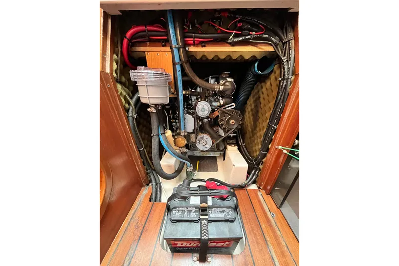 Slide: The Image of Engine compartment of a 1995 Beneteau Oceanis 351 sailboat, featuring battery and wiring. - 16