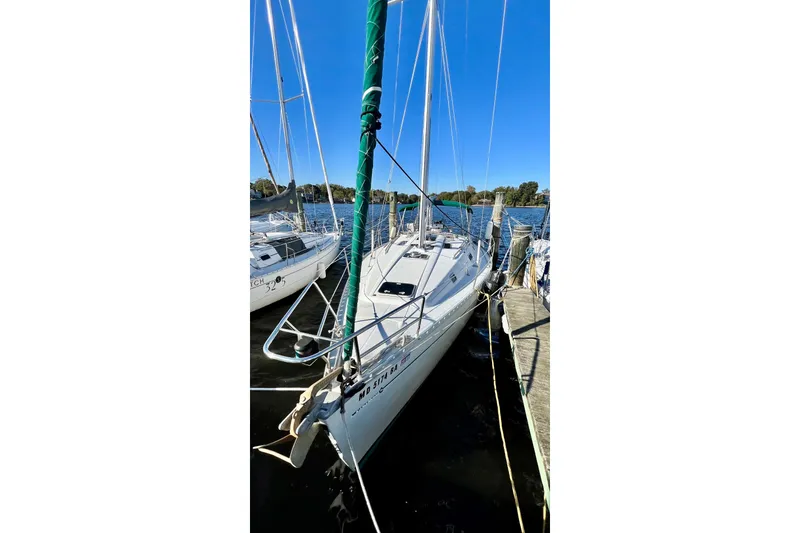 Slide: The Image of 1995 Beneteau Oceanis 351 sailboat docked on a sunny day. - 6